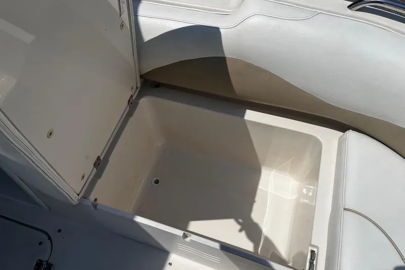 Slide: The Image of Open storage compartment in 2008 Hurricane FD202 boat, featuring white interior. - 13
