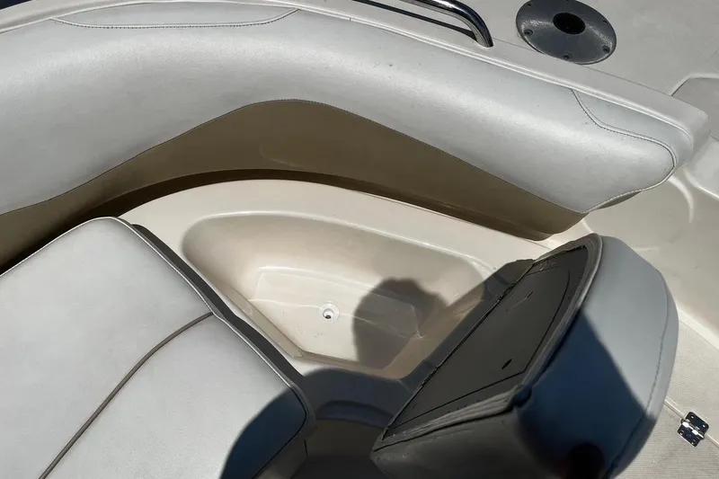 Slide: The Image of 2008 Hurricane FD202 boat interior with open storage compartment and cushioned seating. - 16