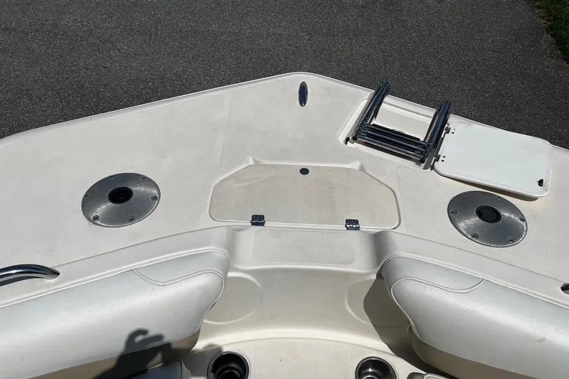 Slide: The Image of 2008 Hurricane FD202 boat deck with seating, ladder, and storage compartments. - 18