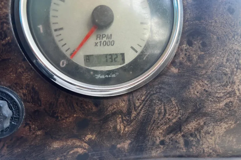 Slide: The Image of Close-up of a 2008 Hurricane FD202 RPM gauge on a textured dashboard. - 19
