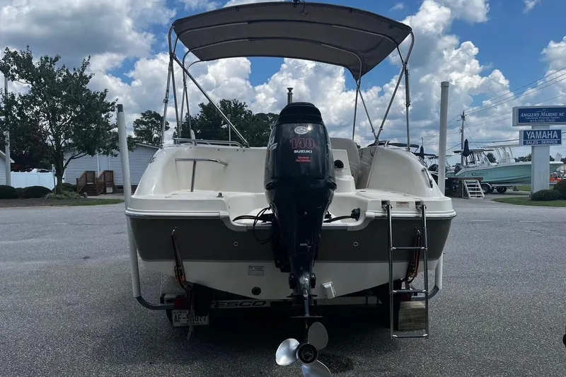 Slide: The Image of 2008 Hurricane FD202 boat with Suzuki 140 outboard motor, parked outdoors under cloudy sky. - 3