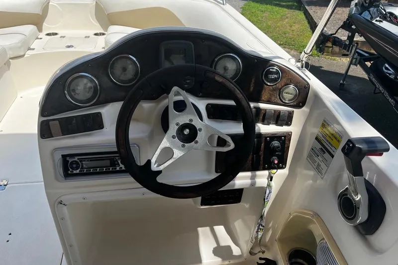 Slide: The Image of Dashboard of a 2008 Hurricane FD202 boat with steering wheel and controls. - 7