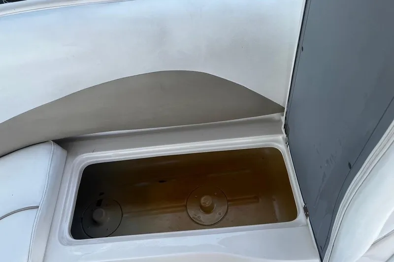 Slide: The Image of Storage compartment in a 2008 Hurricane FD202 boat, featuring a white and gray interior. - 8
