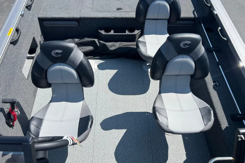 Slide: The Image of 2024 Crestliner 1850 Fish Hawk interior with three gray and black seats. - 10