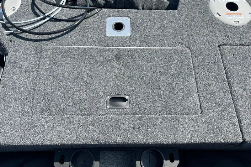 Slide: The Image of 2024 Crestliner 1850 Fish Hawk boat deck with storage compartment and fishing rod holders. - 15