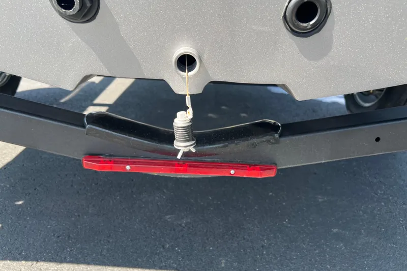 Slide: The Image of Rear view of 2024 Crestliner 1850 Fish Hawk boat with trailer and red reflector. - 17