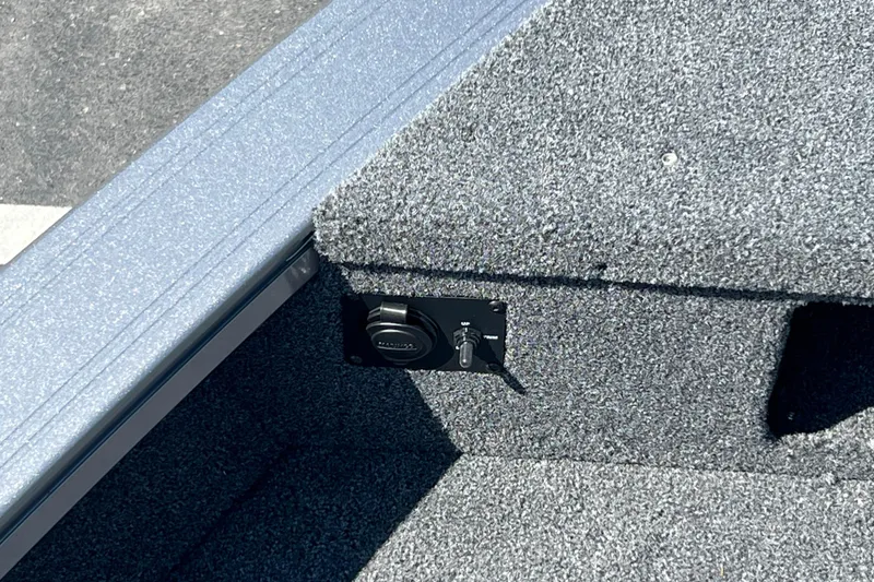 Slide: The Image of 2024 Crestliner 1850 Fish Hawk interior with carpeted flooring and control panel. - 19