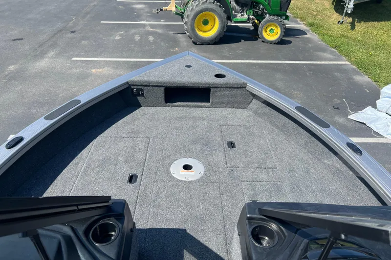 Slide: The Image of 2024 Crestliner 1850 Fish Hawk boat interior with carpeted deck and storage compartments. - 2