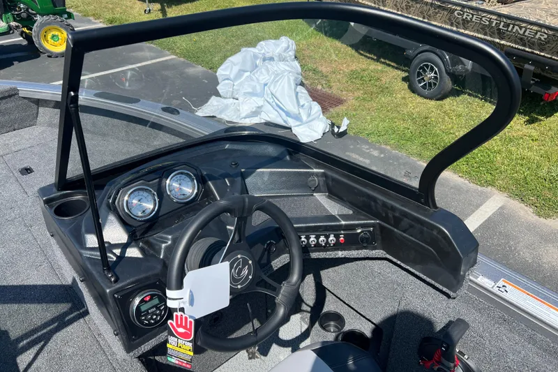 Slide: The Image of 2024 Crestliner 1850 Fish Hawk boat dashboard with steering wheel and gauges. - 7