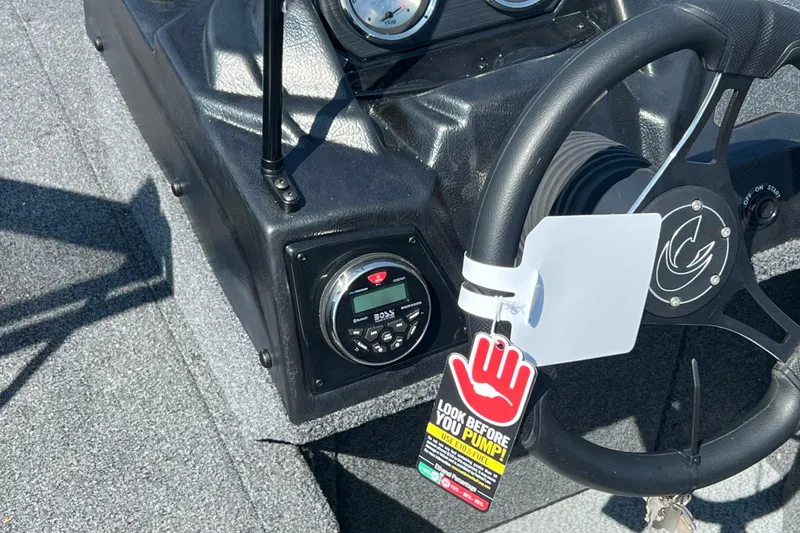 Slide: The Image of 2024 Crestliner 1850 Fish Hawk dashboard with steering wheel and control panel. - 8