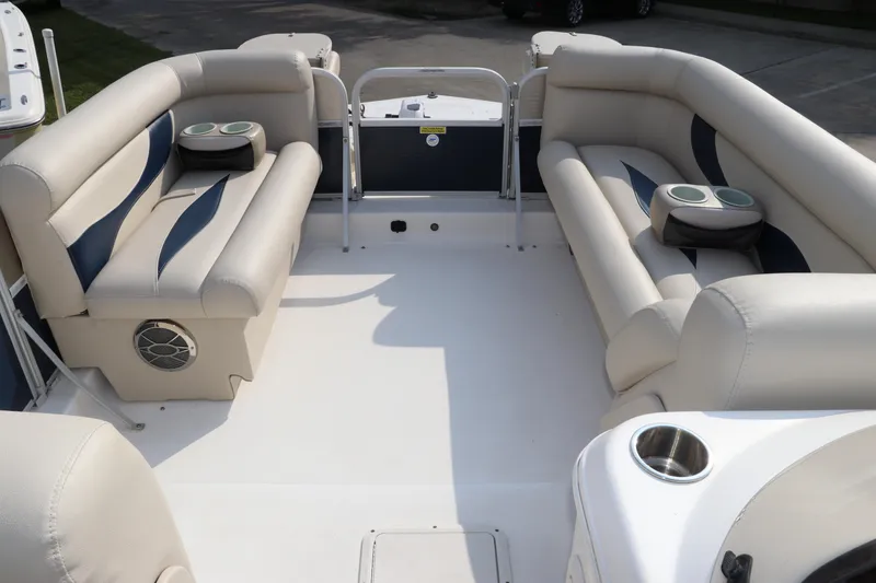 Slide: The Image of 2014 Hurricane FunDeck 226 interior with beige seating and cup holders. - 23