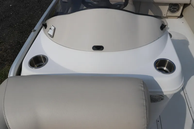 Slide: The Image of 2014 Hurricane FunDeck 226 boat dashboard with cup holders and beige seating. - 24