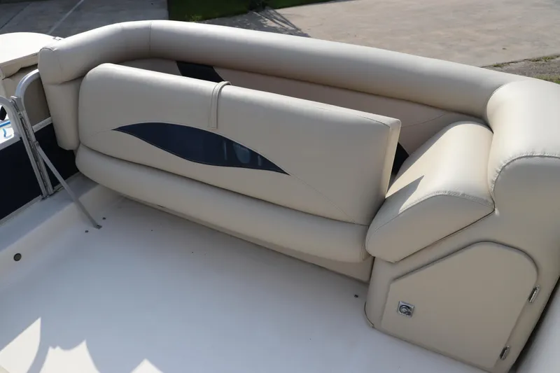 Slide: The Image of 2014 Hurricane FunDeck 226 boat with beige seating and storage compartment. - 28