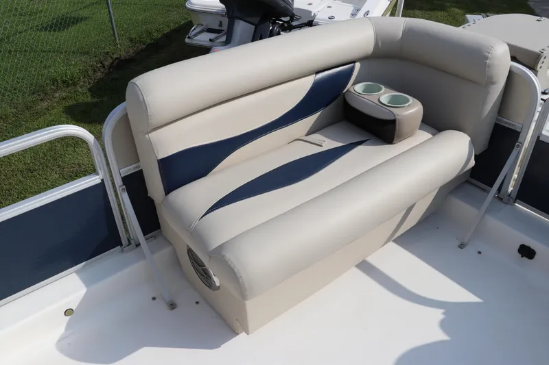 Slide: The Image of 2014 Hurricane FunDeck 226 boat seating with cup holders, featuring beige and blue upholstery. - 30