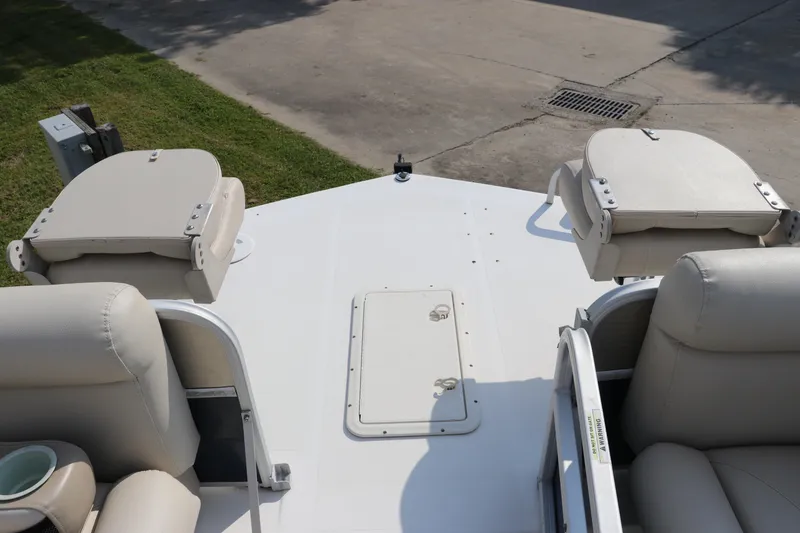 Slide: The Image of 2014 Hurricane FunDeck 226 boat interior with beige seating and storage compartments. - 33