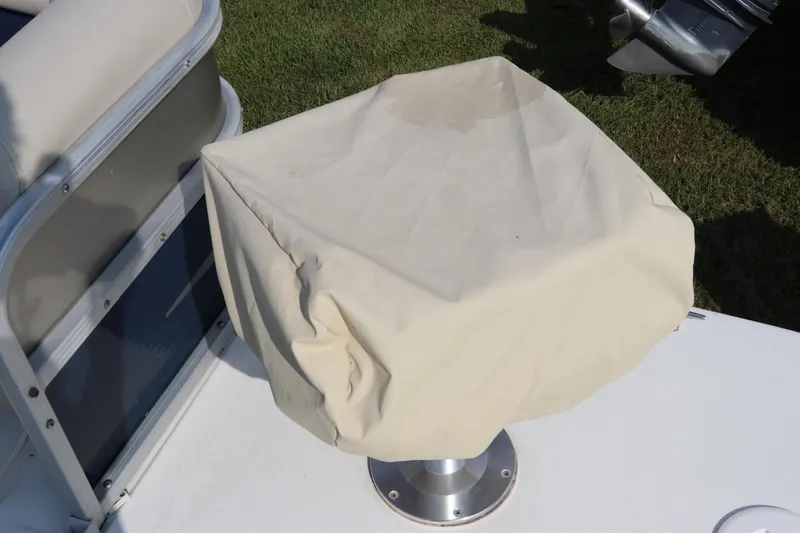 Slide: The Image of Covered seat on a 2014 Hurricane FunDeck 226 boat, with grass in the background. - 41