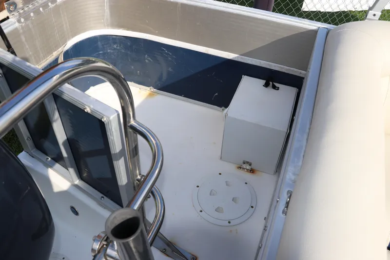 Slide: The Image of 2014 Hurricane FunDeck 226 boat interior with metal railing and storage compartment. - 5