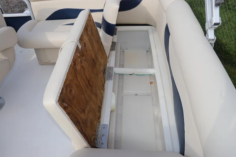 Slide: The Image of 2014 Hurricane FunDeck 226 boat with open storage compartment under cushioned seating. - 8