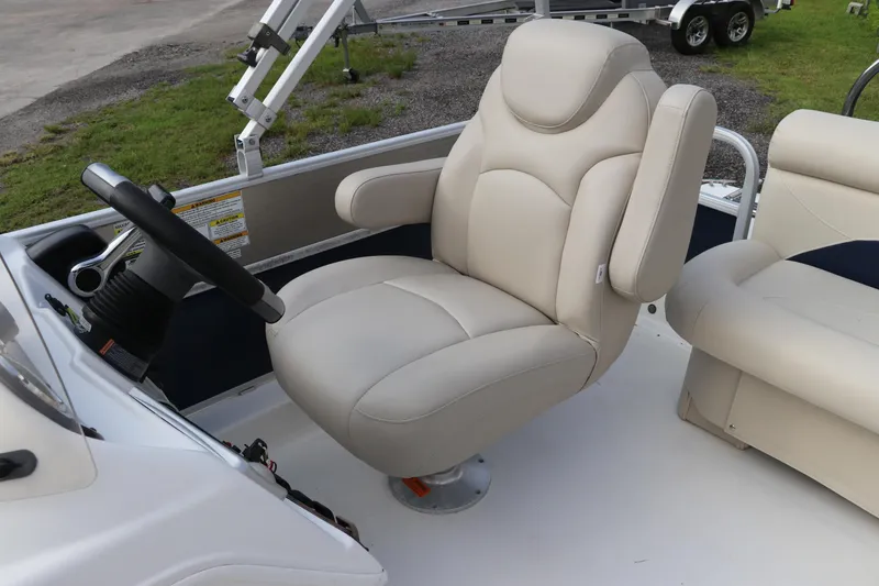 Slide: The Image of 2014 Hurricane FunDeck 226 boat interior with beige captain's chair and steering wheel. - 9