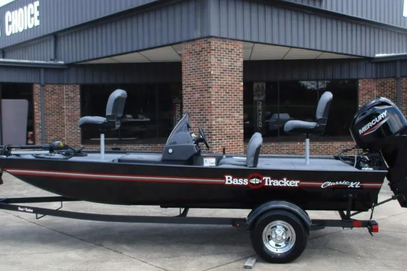 The Image of 2026 Tracker BASS TRACKER® Classic XL boat on trailer, parked outside a building. - 1