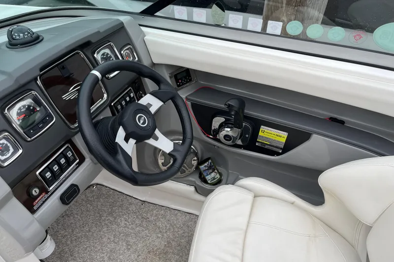 Slide: The Image of 2013 Chaparral 226 SSi Wide Tech boat dashboard with steering wheel and controls. - 11