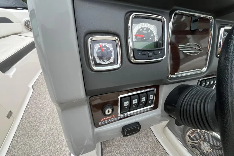 Slide: The Image of Dashboard of 2013 Chaparral 226 SSi Wide Tech boat with gauges and controls. - 12