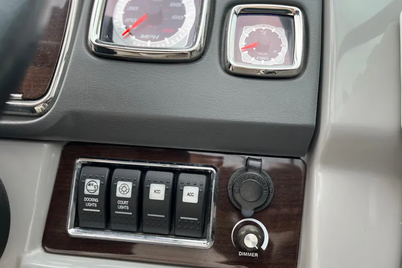 Slide: The Image of Dashboard controls of a 2013 Chaparral 226 SSi Wide Tech boat, featuring gauges and switches. - 13