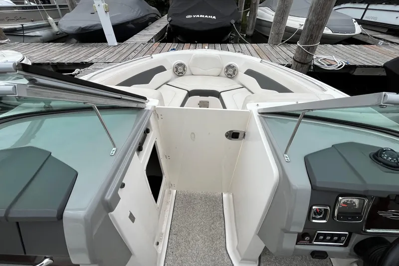 Slide: The Image of 2013 Chaparral 226 SSi Wide Tech boat interior with open bow seating and dashboard view. - 15