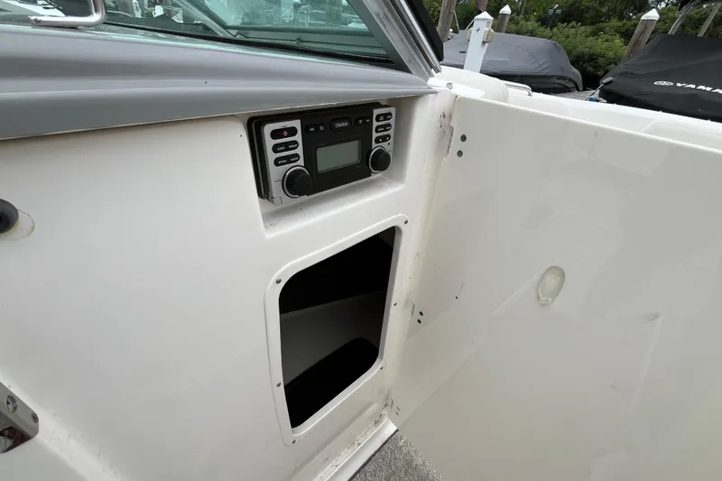 Slide: The Image of 2013 Chaparral 226 SSi Wide Tech boat interior with stereo system and storage compartment. - 17