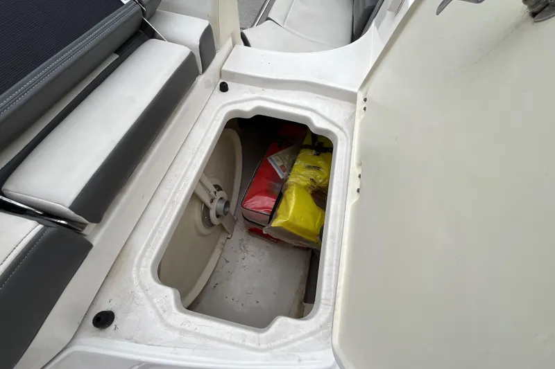 Slide: The Image of Storage compartment in 2013 Chaparral 226 SSi Wide Tech boat, containing bags and equipment. - 20