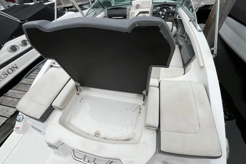 Slide: The Image of 2013 Chaparral 226 SSi Wide Tech boat interior with open storage compartment. - 3
