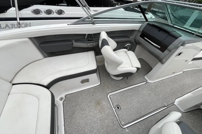 Slide: The Image of Interior of 2013 Chaparral 226 SSi Wide Tech boat with seating and dashboard. - 7