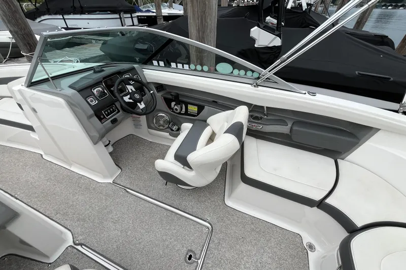 Slide: The Image of 2013 Chaparral 226 SSi Wide Tech boat interior with steering wheel and seating. - 8