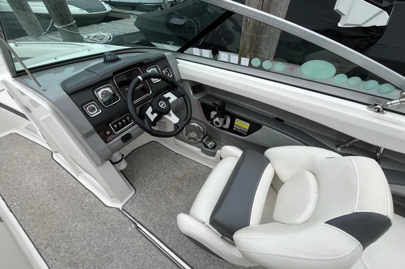 Slide: The Image of 2013 Chaparral 226 SSi Wide Tech boat interior with steering wheel and seating. - 9