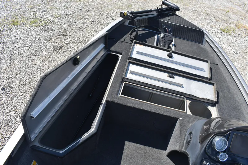 Slide: The Image of 2015 Lowe Stinger 175 boat interior with open storage compartments and control panel. - 11