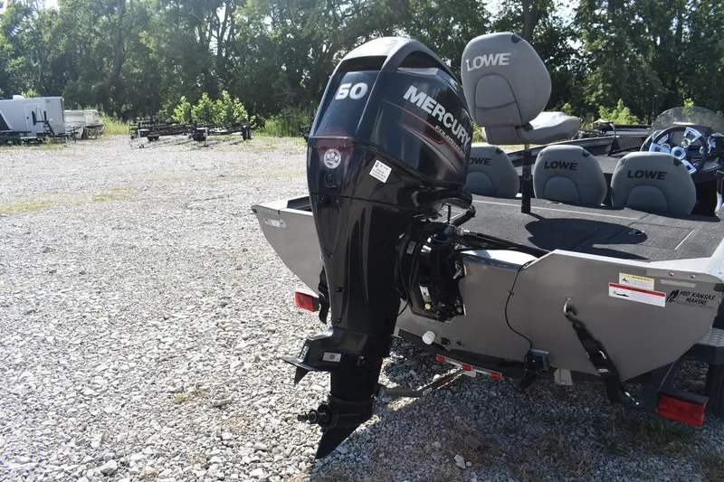 Slide: The Image of 2015 Lowe Stinger 175 boat with Mercury 50 HP outboard motor in a gravel lot. - 13