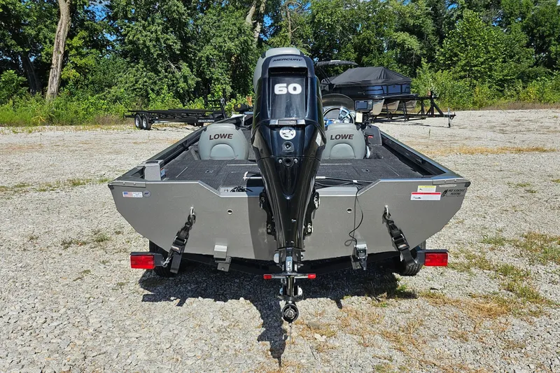 Slide: The Image of 2015 Lowe Stinger 175 boat with Mercury 60 engine, parked on gravel lot. - 6