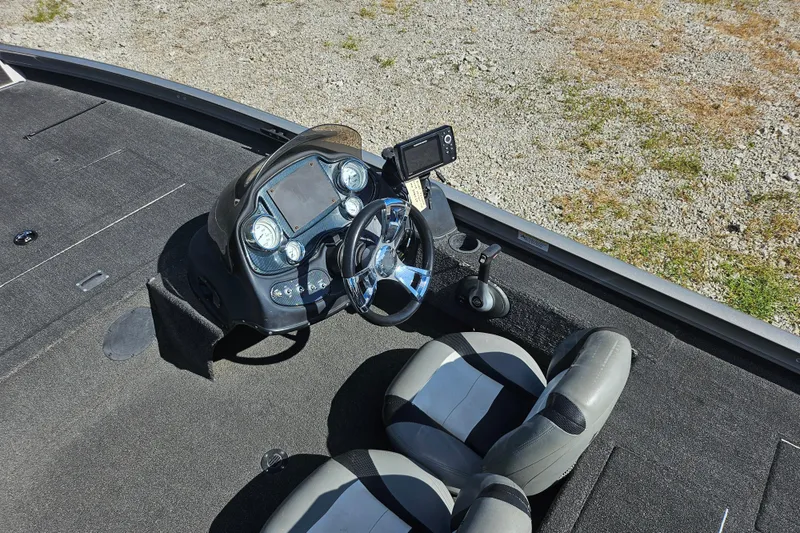 Slide: The Image of 2015 Lowe Stinger 175 boat interior with steering console and dual seats. - 7