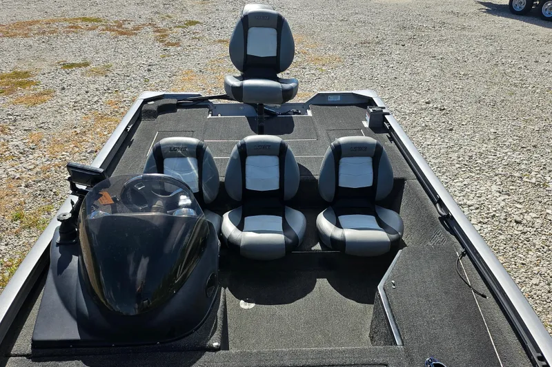 Slide: The Image of 2015 Lowe Stinger 175 boat interior with four seats on gravel surface. - 9