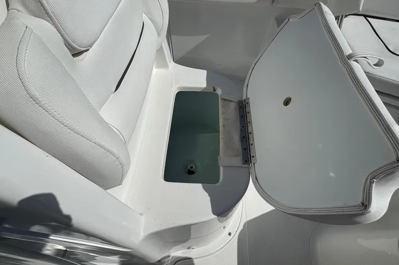 Slide: The Image of Open storage compartment on 2012 Sea Hunt Triton 225 boat with cushioned seating. - 10
