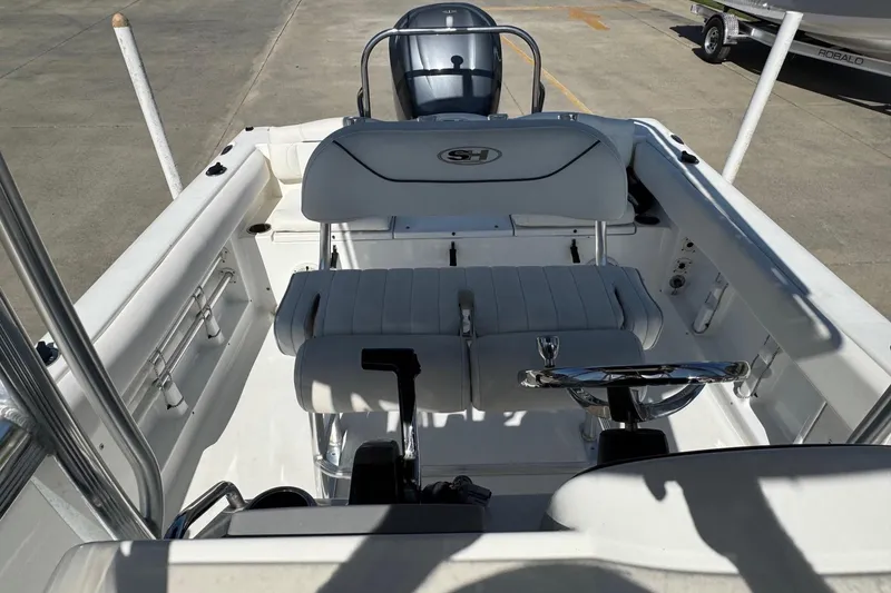 Slide: The Image of 2012 Sea Hunt Triton 225 boat interior with steering wheel and seating. - 11
