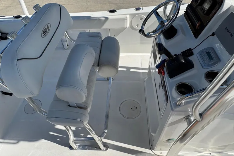 Slide: The Image of 2012 Sea Hunt Triton 225 boat interior with steering console and seating. - 12