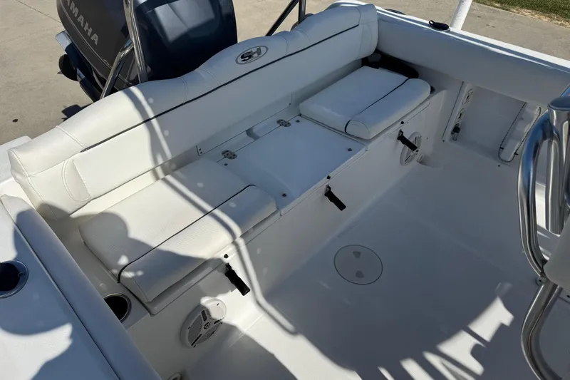 Slide: The Image of 2012 Sea Hunt Triton 225 boat interior with white seating and Yamaha engine. - 17