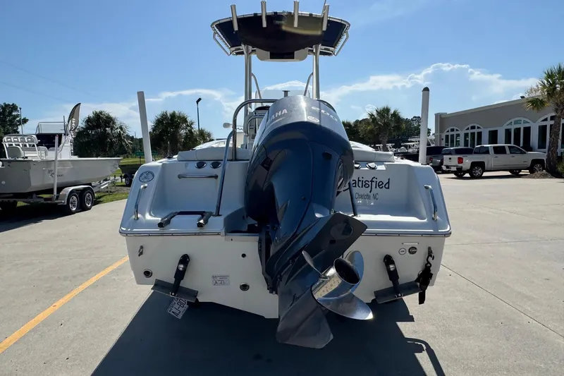 Slide: The Image of 2012 Sea Hunt Triton 225 boat with Yamaha outboard motor, parked outdoors. - 3