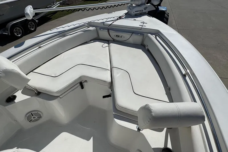 Slide: The Image of 2012 Sea Hunt Triton 225 boat interior with cushioned seating and Minn Kota trolling motor. - 7