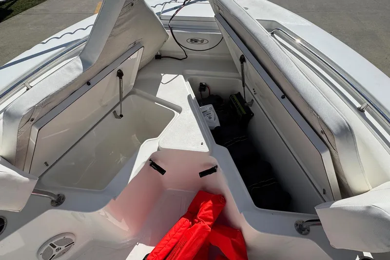 Slide: The Image of Interior of a 2012 Sea Hunt Triton 225 boat with open storage compartments. - 8