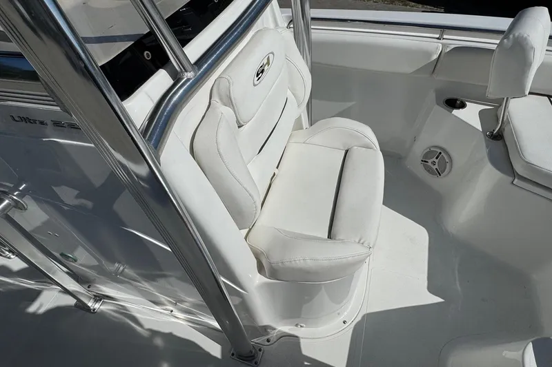 Slide: The Image of 2012 Sea Hunt Triton 225 boat interior with white seating and stainless steel railings. - 9
