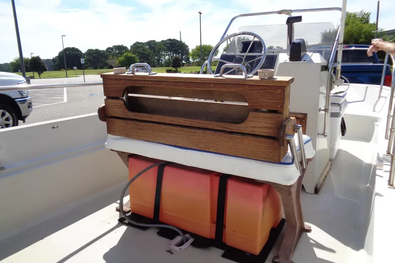 Slide: The Image of 1986 Boston Whaler Montauk 17 CC interior with wooden seating and steering console. - 13
