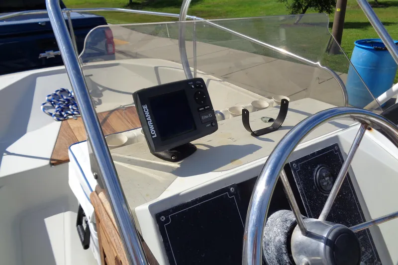 Slide: The Image of 1986 Boston Whaler Montauk 17 CC helm with Lowrance Elite-5 GPS and steering wheel. - 16