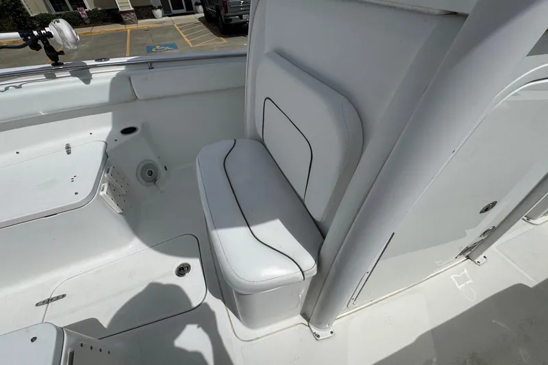 Slide: The Image of 2014 Sea Hunt Gamefish 25 boat interior with white seating and storage compartments. - 12